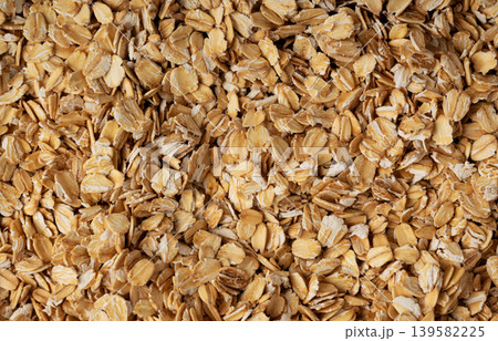 Oat flakes textured pattern, rolled oatmeal macro background Oat flakes textured pattern, rolled oatmeal macro background 139582225