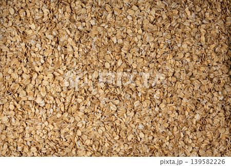 Oat flakes textured pattern, rolled oatmeal macro background Oat flakes textured pattern, rolled oatmeal macro background 139582226