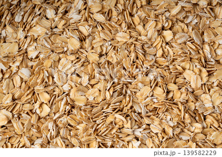 Oat flakes textured pattern, rolled oatmeal macro background 139582229