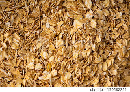 Oat flakes textured pattern, rolled oatmeal macro background Oat flakes textured pattern, rolled oatmeal macro background 139582231