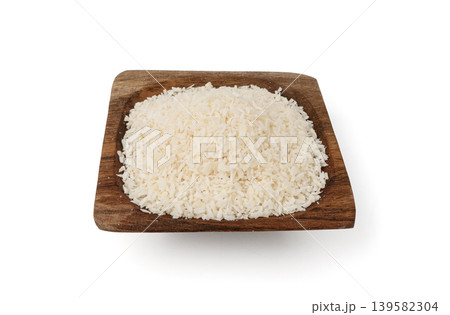 Grated coconut powder. Dry coco flakes pile, shredded desiccated coconut, tropical fruit chips 139582304