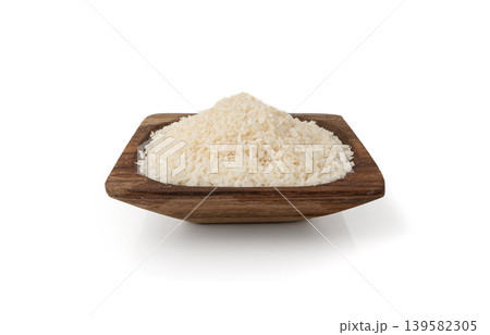 Grated coconut powder. Dry coco flakes pile, shredded desiccated coconut, tropical fruit chips Grated coconut powder. Dry coco flakes pile, shredded desiccated coconut, tropical fruit chips 139582305