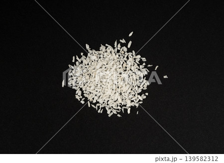 Grated coconut powder. Dry coco flakes pile, shredded desiccated coconut, tropical fruit chips Grated coconut powder. Dry coco flakes pile, shredded desiccated coconut, tropical fruit chips 139582312