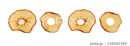 Dry apple slices isolated, dried apple chips, healthy fruit snack Dry apple slices isolated, dried apple chips, healthy fruit snack 139582384
