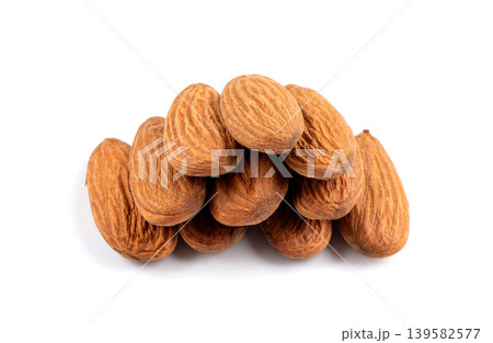Almonds pile isolated, nut group, almond seeds, brown scattered fruit kernels on white background 139582577