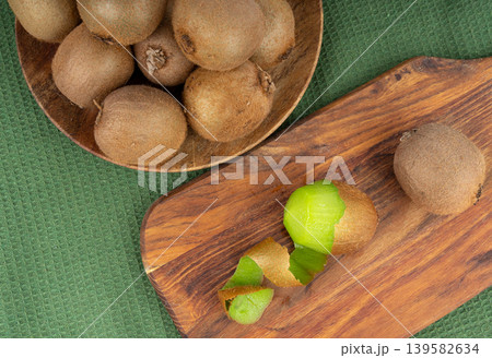 Kiwi fruit peel on wood cutting board Kiwi fruit peel on wood cutting board 139582634