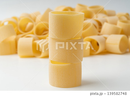 Raw Calamarata Big Pasta Isolated, Homemade Dry Macaroni, Italian Raw Round Noodle Raw Calamarata Big Pasta Isolated, Homemade Dry Macaroni, Italian Raw Round Noodle 139582748
