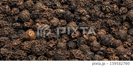 Black pepper whole grains pattern, peppercorn macro seeds closeup Black pepper whole grains pattern, peppercorn macro seeds closeup 139582760