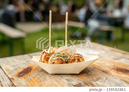 Takoyaki - traditional Japanese street food, outdoor snack with octopus Takoyaki fried balls Takoyaki - traditional Japanese street food, outdoor snack with octopus Takoyaki fried balls 139582861