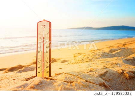 Thermometer on sunset sea beach in tropical. Extremely hot day. Thermometer measuring air  139583328
