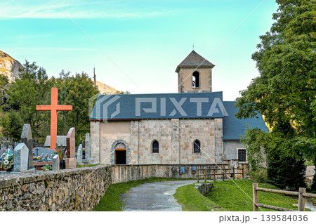 The church Notre Dame du Bon Port with cemetery in the mountain village Gavarnie-Gedre in Hautes-Pyrenees, France. The church Notre Dame du Bon Port with cemetery in the mountain village Gavarnie-Gedre in Hautes-Pyrenees, France. 139584036