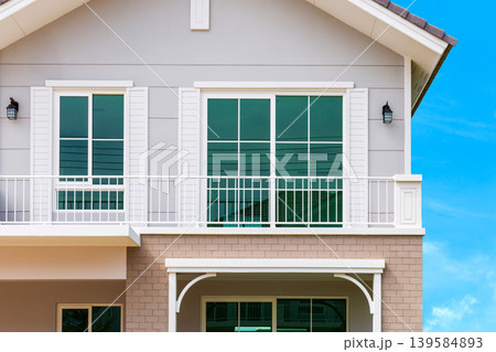 Modern Two-Story House Exterior with Blue Sky Background Modern Two-Story House Exterior with Blue Sky Background 139584893