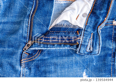 Blue Jeans with Open Metal Zipper and Button Detail Blue Jeans with Open Metal Zipper and Button Detail 139584944