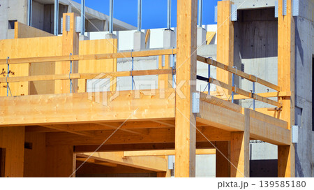 Laminate wood floors and supports of a mass timber multi story green, sustainable office building construction project. The building structure also has concrete walls. Laminate wood floors and supports of a mass timber multi story green, sustainable office building construction project. The building structure also has concrete walls. 139585180