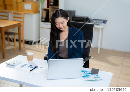 woman using mobile phone in modern office with laptop and digital tablet computer. 139585653