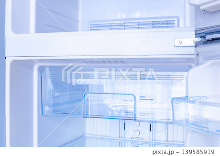 new modern refrigerator opens to reveal the inside, empty refrigerator 139585919