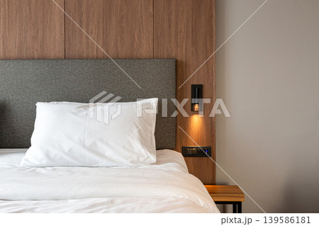 Comfortable bed with pillows and clean white blankets. In the modern bedroom Comfortable bed with pillows and clean white blankets. In the modern bedroom 139586181