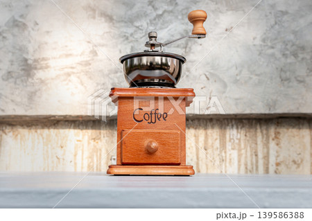 Vintage Coffee Grinder on Wood Log at Camping Site Vintage Coffee Grinder on Wood Log at Camping Site 139586388