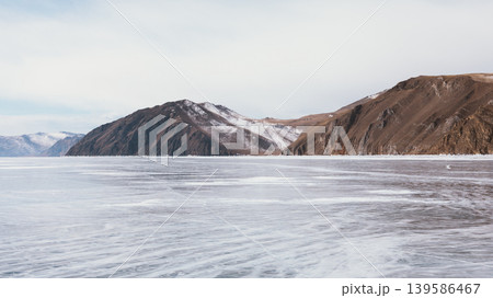Frozen Lake Baikal winter landscape with mountains and wide ice horizon Frozen Lake Baikal winter landscape with mountains and wide ice horizon 139586467