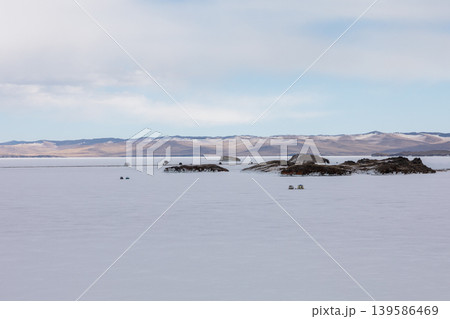 Frozen Lake Baikal Small Sea with islands and winter mountains under cloudy sky Frozen Lake Baikal Small Sea with islands and winter mountains under cloudy sky 139586469