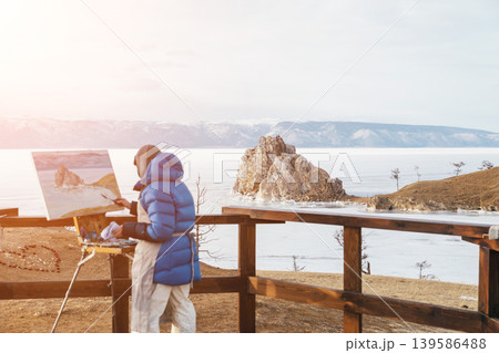 Artist painting Shamanka Rock viewpoint on Olkhon Island at Lake Baikal Artist painting Shamanka Rock viewpoint on Olkhon Island at Lake Baikal 139586488