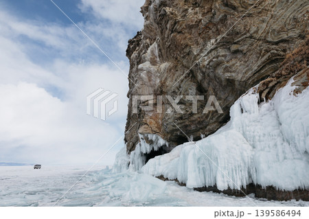 Frozen cliffs and icicles on Lake Baikal shore with winter ice landscape Frozen cliffs and icicles on Lake Baikal shore with winter ice landscape 139586494