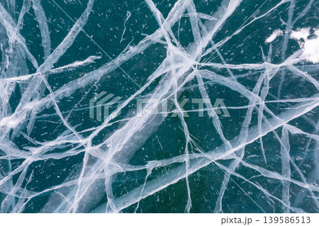 Abstract cracked ice texture on frozen Lake Baikal surface in winter background Abstract cracked ice texture on frozen Lake Baikal surface in winter background 139586513