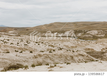 Vast steppe and rocky hills landscape in Altai under overcast sky, Russia Vast steppe and rocky hills landscape in Altai under overcast sky, Russia 139586617