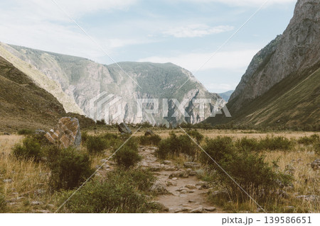 Scenic trail in Chulyshman Valley with rugged mountains and steppe landscape Scenic trail in Chulyshman Valley with rugged mountains and steppe landscape 139586651