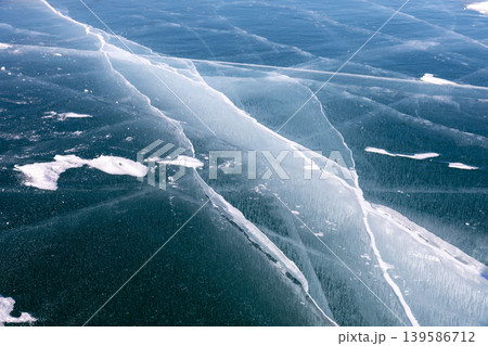 Aerial view of cracked blue ice surface on Lake Baikal in winter, Siberia Aerial view of cracked blue ice surface on Lake Baikal in winter, Siberia 139586712