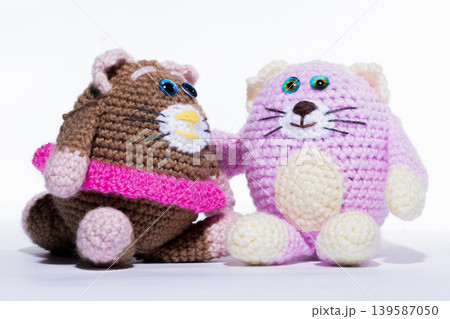 Knitted white cat on a white background Knitted white cat on a white background 139587050