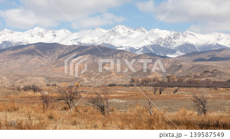 Snow-capped Tian Shan mountains and dry valley landscape in Kyrgyzstan, Central Asia Snow-capped Tian Shan mountains and dry valley landscape in Kyrgyzstan, Central Asia 139587549