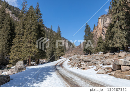 Snowy mountain road through Grigoriev Gorge with pine forest in winter Snowy mountain road through Grigoriev Gorge with pine forest in winter 139587552
