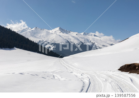 Winter mountain landscape in Grigoriev Gorge with snowy road and peaks Winter mountain landscape in Grigoriev Gorge with snowy road and peaks 139587556