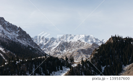 Snowy mountain landscape in Barskoon Gorge with conifer forest, Kyrgyzstan Snowy mountain landscape in Barskoon Gorge with conifer forest, Kyrgyzstan 139587600