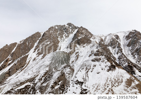 Snowy mountain ridge in Barskoon Gorge, Tien Shan range, Kyrgyzstan Snowy mountain ridge in Barskoon Gorge, Tien Shan range, Kyrgyzstan 139587604