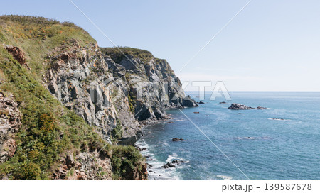 Rocky sea cliffs and blue water coastline at Velyuchinskaya Bay, Kamchatka Rocky sea cliffs and blue water coastline at Velyuchinskaya Bay, Kamchatka 139587678