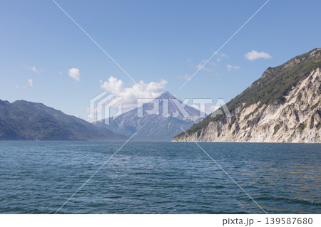 Velyuchinskaya Bay seascape with volcanic mountains and coastal cliffs, Kamchatka Velyuchinskaya Bay seascape with volcanic mountains and coastal cliffs, Kamchatka 139587680