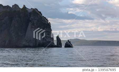 Coastal cliffs and sea stacks in Avacha Bay, Kamchatka at cloudy evening Coastal cliffs and sea stacks in Avacha Bay, Kamchatka at cloudy evening 139587695