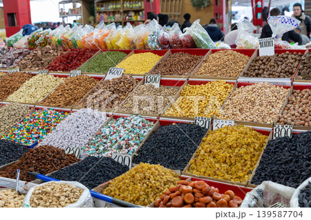 Colorful dried fruits, nuts and sweets for sale at Osh Bazaar in Bishkek market Colorful dried fruits, nuts and sweets for sale at Osh Bazaar in Bishkek market 139587704