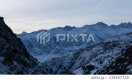 Winter mountain landscape in Chunkurchak Valley with snowy peaks at dusk 139587729