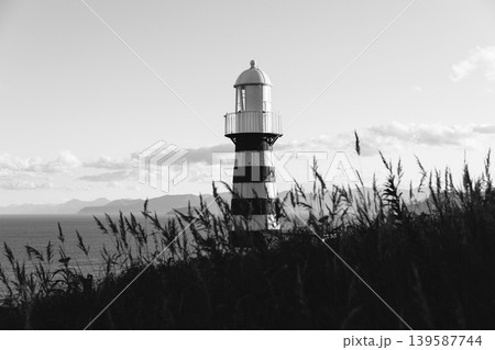 Mayachny Cape lighthouse on Kamchatka coast, black and white seascape view 139587744