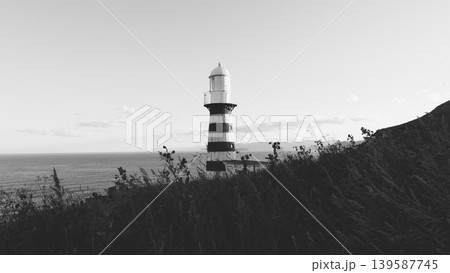 Mayachny Cape lighthouse on coastal cliff above the Pacific Ocean, Kamchatka Mayachny Cape lighthouse on coastal cliff above the Pacific Ocean, Kamchatka 139587745