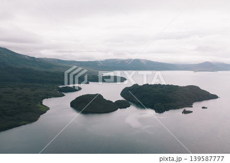 Aerial view of Kuril Lake with forested islands and volcanic landscape Aerial view of Kuril Lake with forested islands and volcanic landscape 139587777