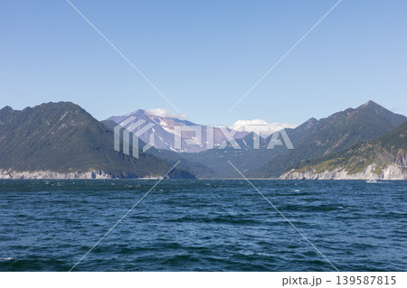 Coastal mountains and volcanic peak above the sea in Kamchatka peninsula, Russia Coastal mountains and volcanic peak above the sea in Kamchatka peninsula, Russia 139587815