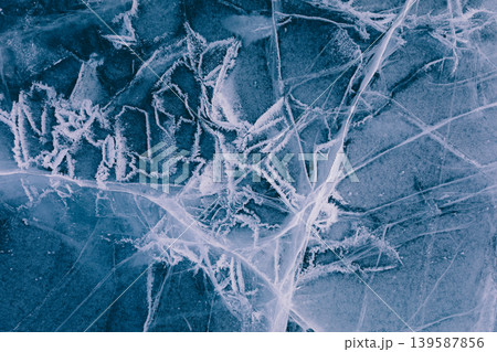 Frozen cracks and frost patterns on Lake Baikal ice, winter abstract texture Frozen cracks and frost patterns on Lake Baikal ice, winter abstract texture 139587856