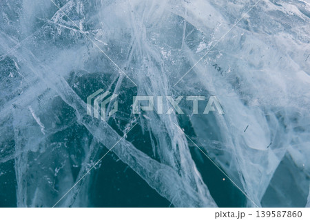 Abstract cracked blue ice texture on Lake Baikal in winter, close up background Abstract cracked blue ice texture on Lake Baikal in winter, close up background 139587860