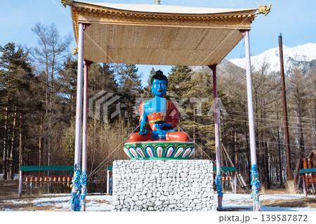 Colorful outdoor Buddha statue under pavilion in Arshan village, Buryatia Colorful outdoor Buddha statue under pavilion in Arshan village, Buryatia 139587872