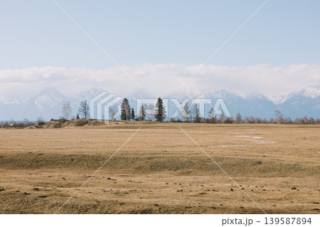 Wide steppe landscape with Sayan Mountains near Arshan village, Buryatia Wide steppe landscape with Sayan Mountains near Arshan village, Buryatia 139587894
