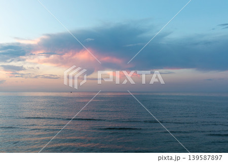 Calm sunset over the Caspian Sea horizon in Derbent with pastel clouds Calm sunset over the Caspian Sea horizon in Derbent with pastel clouds 139587897